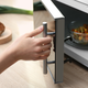 hand closing door to microwave